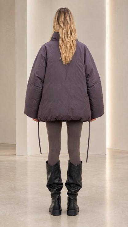 Back view of model wearing slate purple oversized winter puffer jacket