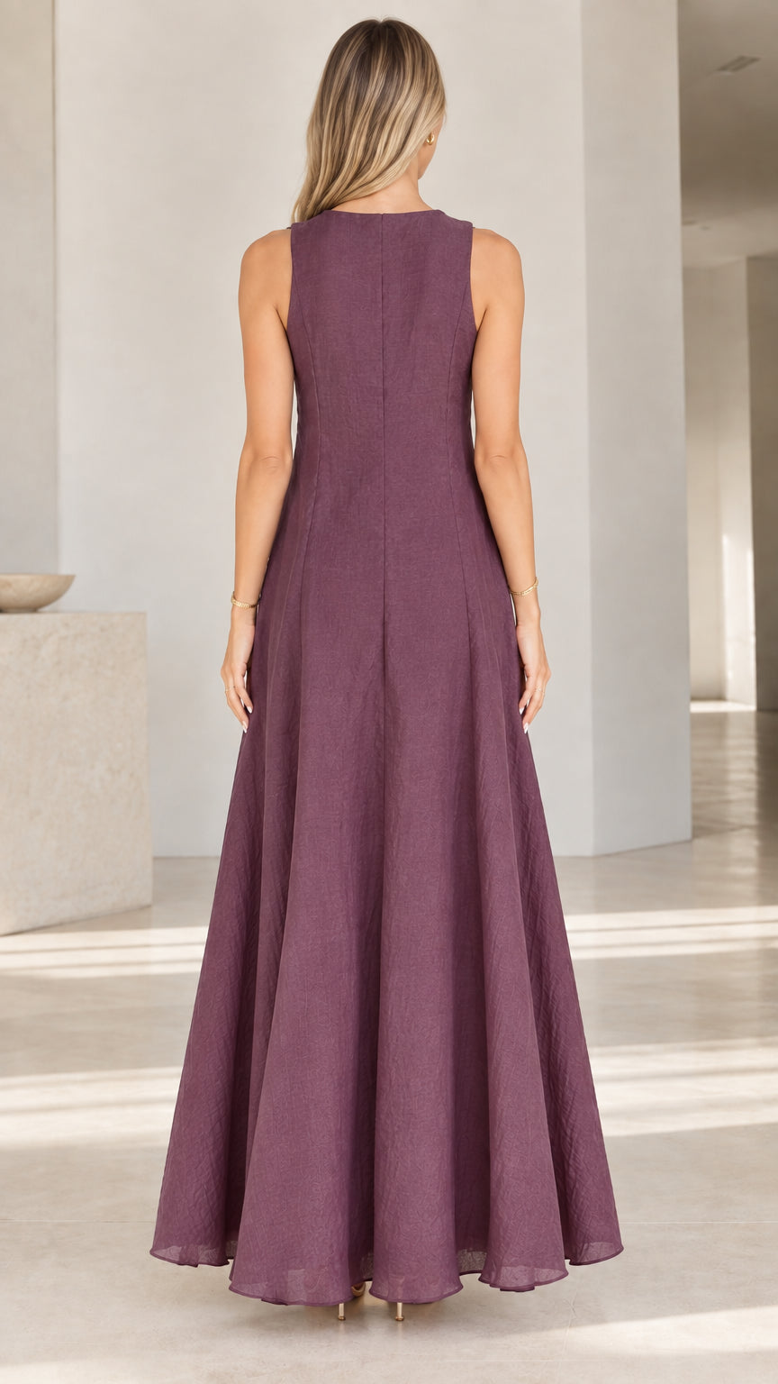 Back view of woman wearing Plum textured sleeveless maxi dress