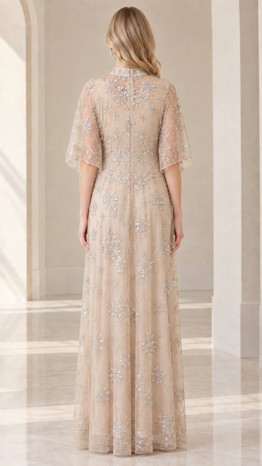 Back view of woman wearing champagne floor-length beaded formal dress