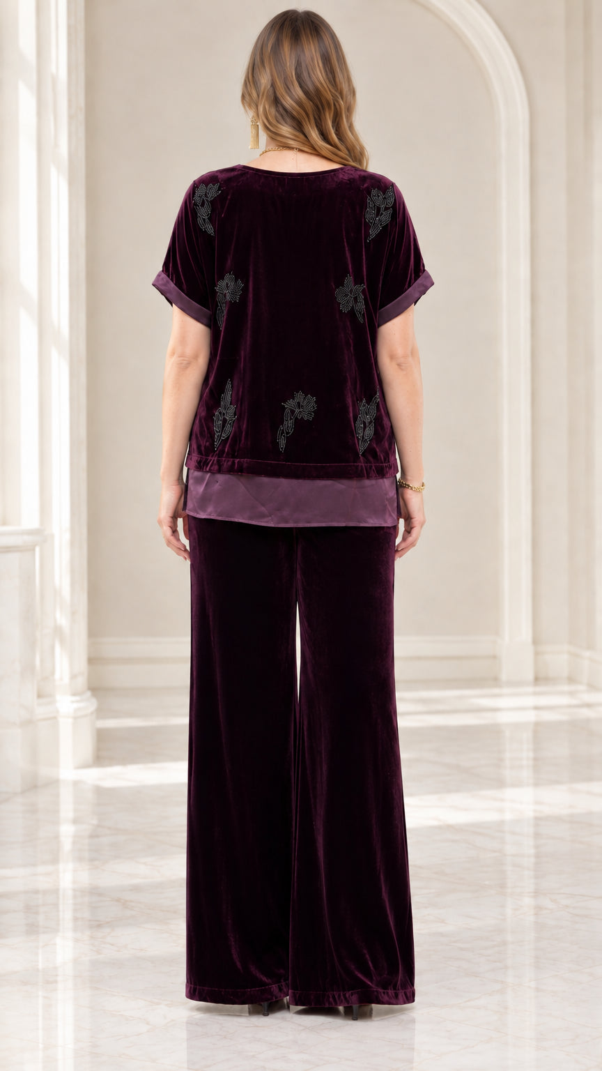 Back view of model in Plum velvet set showing beaded detail and satin trim