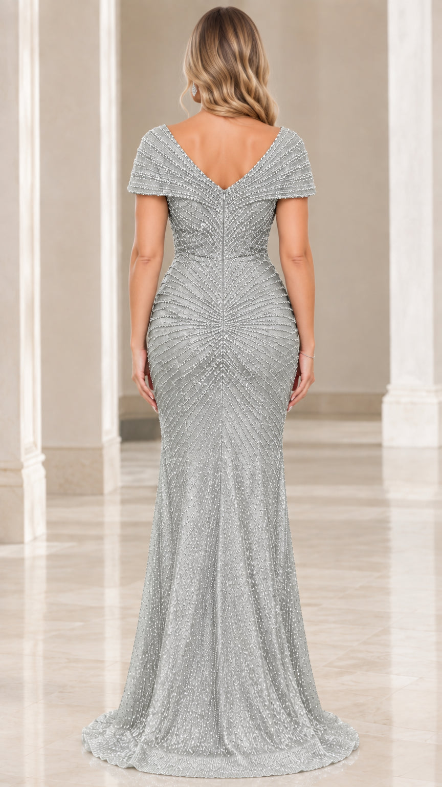 Back view of model in the silver beaded gown highlighting the elegant V-back design