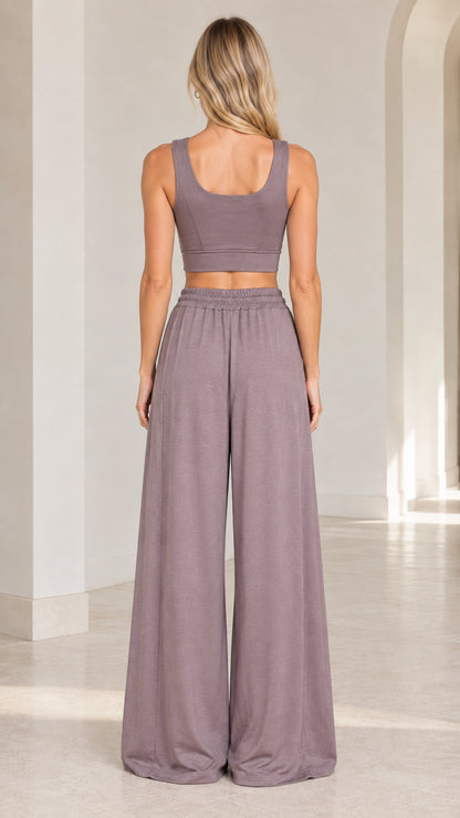 Back view of woman wearing Dusty Mauve sleeveless crop top and wide-leg pants