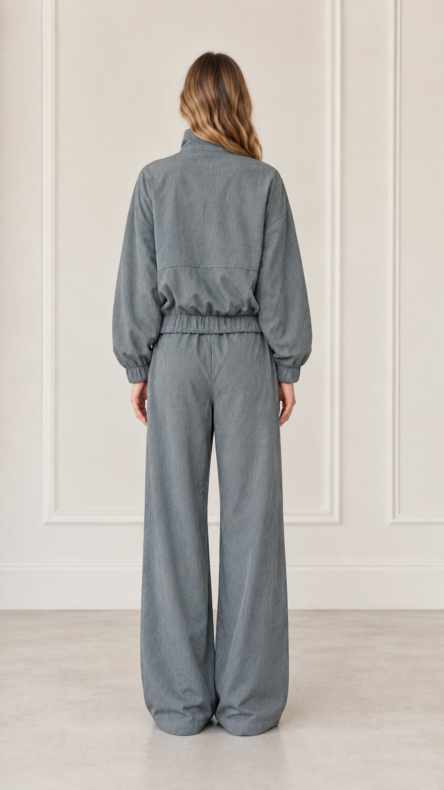 Back view of woman wearing Dusty Blue relaxed fit jacket and wide-leg pants
