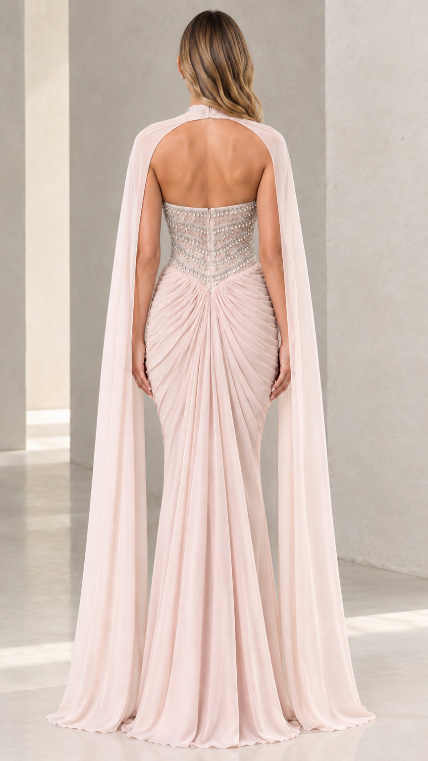 Back view of Blush Pink cape evening gown showing open back and ruched detail