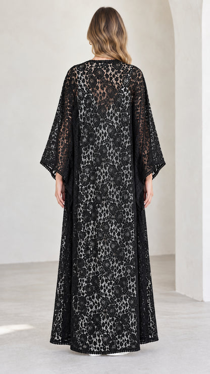 Back view of model in full-length black floral lace kimono cardigan