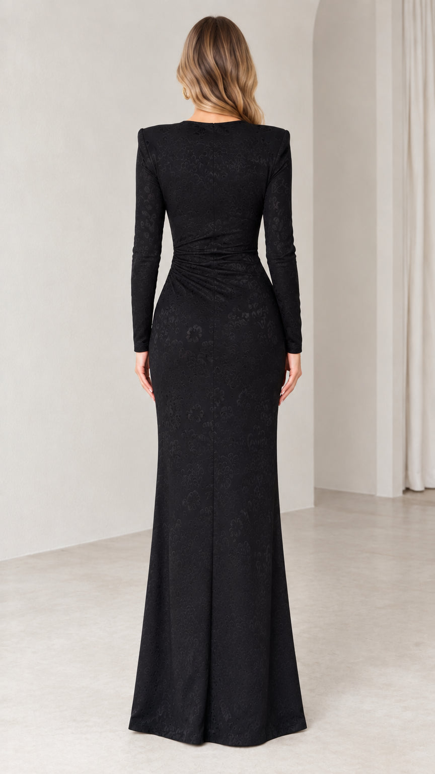 Back view of woman wearing black jacquard evening maxi dress with structured shoulders