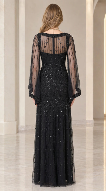 Back view of black evening gown highlighting sheer illusion back and zipper closure