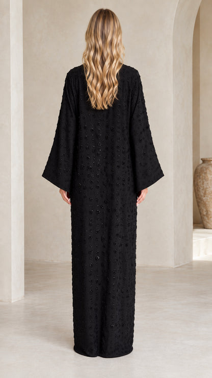 Back view of woman wearing Black flowing embellished abaya dress