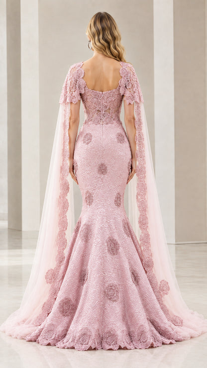 Back view of dusty rose capelet evening gown showing sheer back and flared mermaid skirt