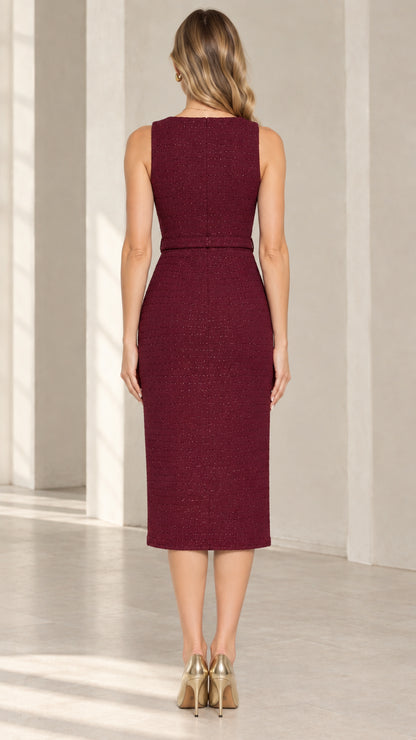 Back view of model wearing burgundy midi sheath dress with tailored darts
