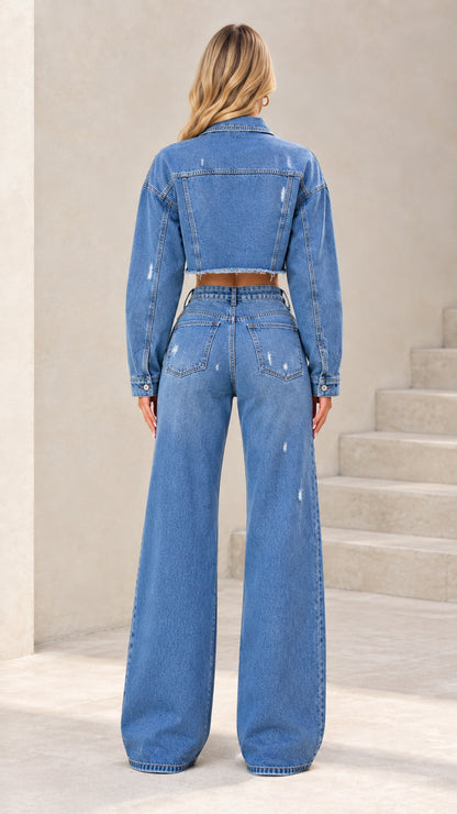 Back view of woman wearing Classic Blue 2-piece denim set showing cropped jacket cut and pocket placement