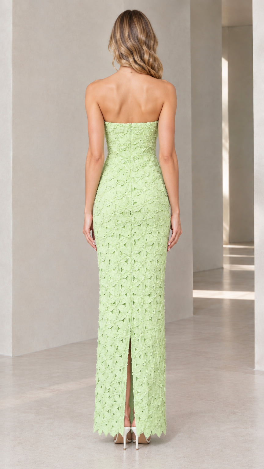 Back view of mint green strapless floral column dress showing center back slit