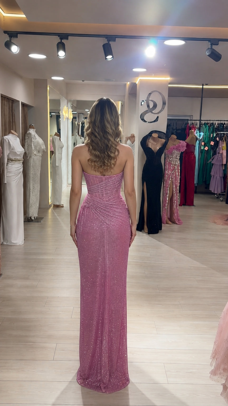 Back view of model in pink one-shoulder floor-length sequin dress