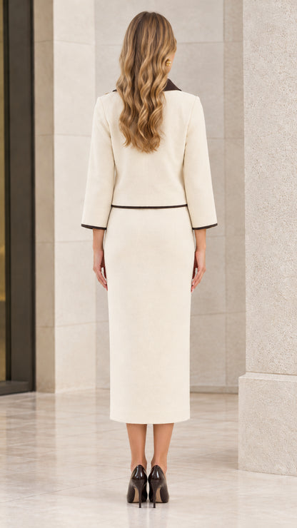 Back view of model showing cream midi pencil skirt with back slit and tailored jacket