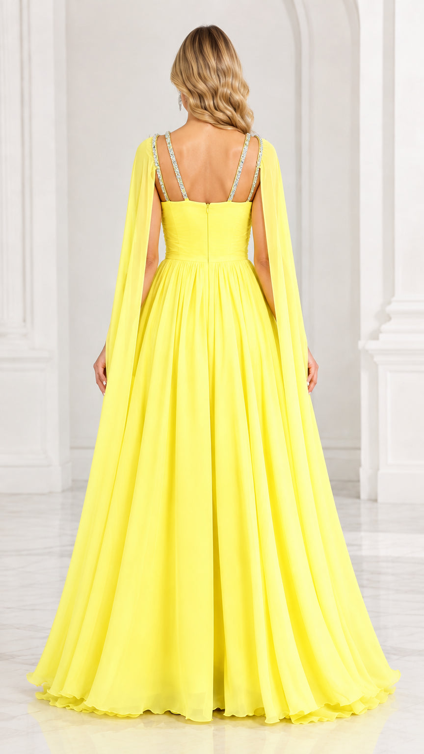Back view of yellow chiffon evening dress with double embellished straps and flowing cape