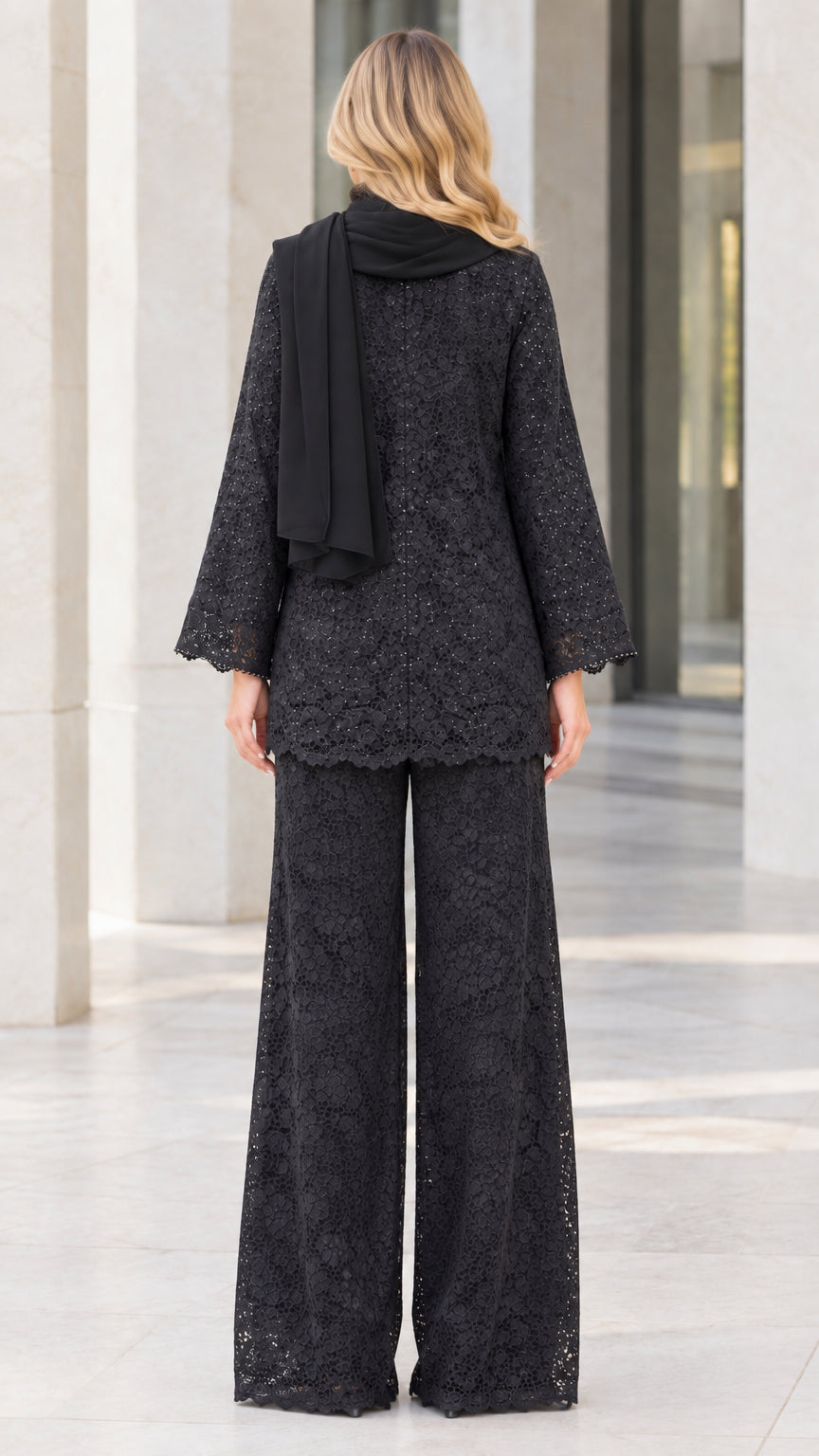 Back view of model in black sequin lace cardigan and wide-leg pants set with scarf