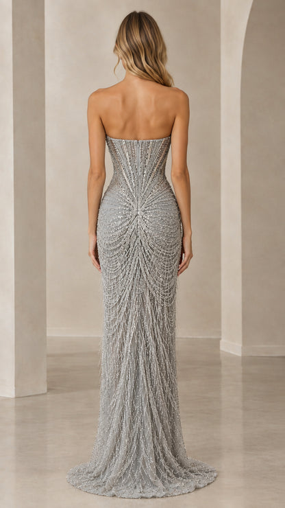 Back view of model showing the corset boning and sweeping beaded skirt