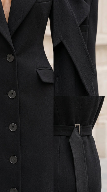 Close-up detail of black blazer dress lapel, buttons, and back waist buckle