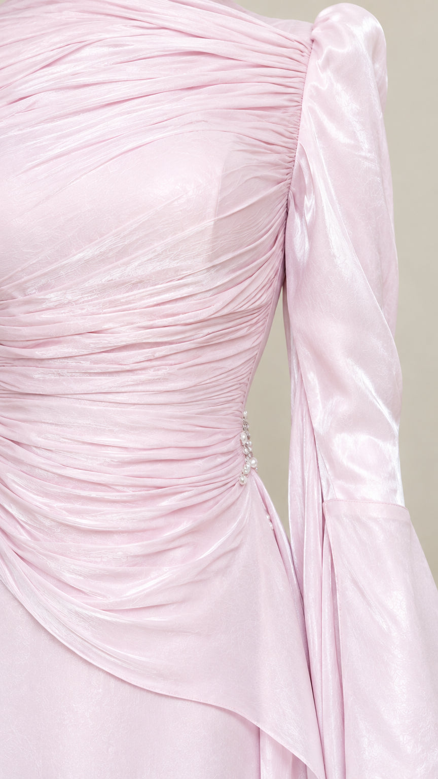 Close-up detail of gathered ruched bodice and draped waist detail with side embellishment