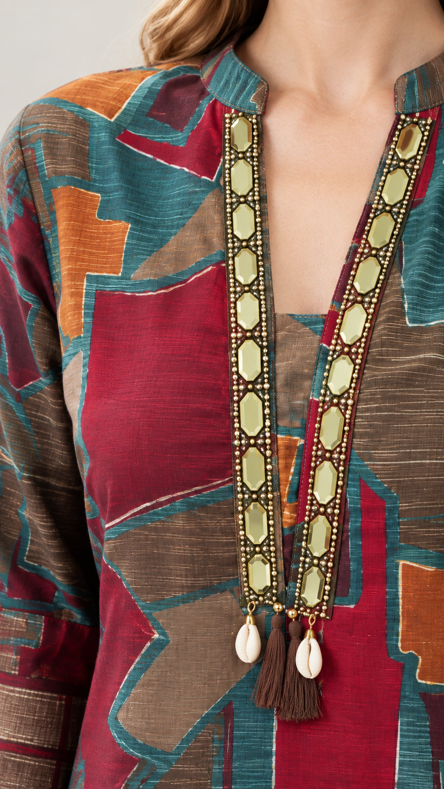 Close-up detail of embellished neckline with trims and shell tassel accents