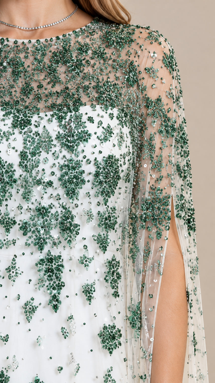 Close up of emerald green sequin embroidery on sheer neckline