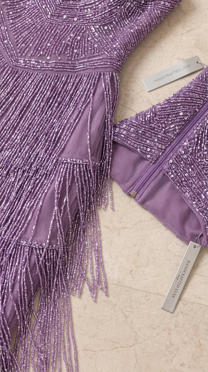 Close-up detail of sequin embroidery, beaded fringe, and back zipper lining