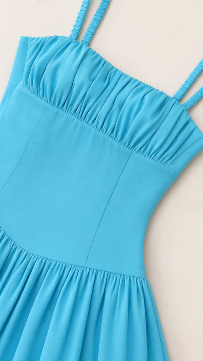 Close-up detail of sky blue ruched bustline, slim straps, and fitted bodice