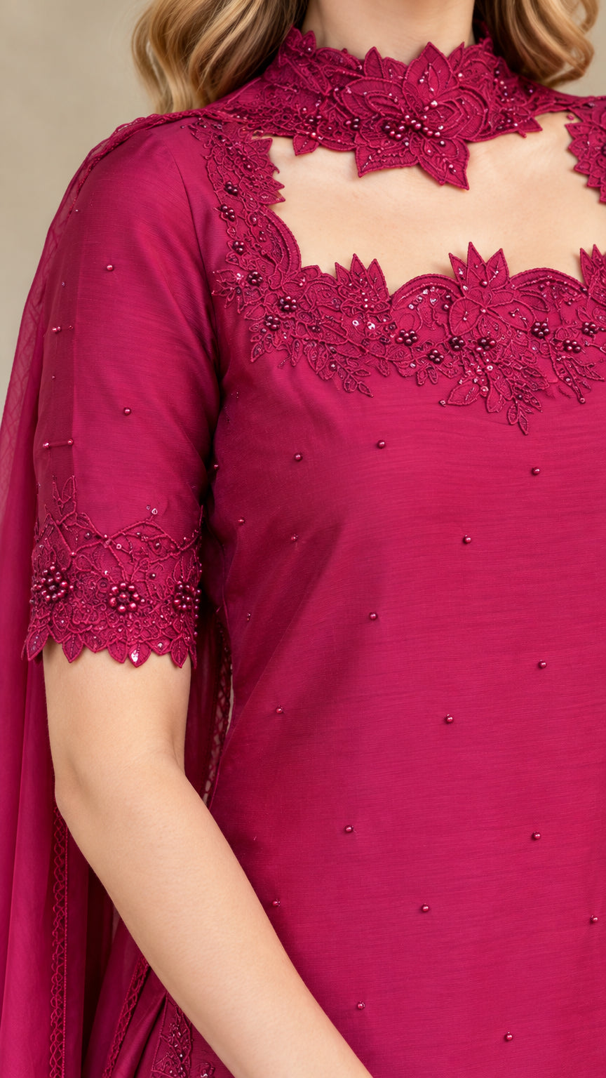 Close-up of magenta tunic featuring beaded lace cutout neckline and embroidered sleeve cuffs