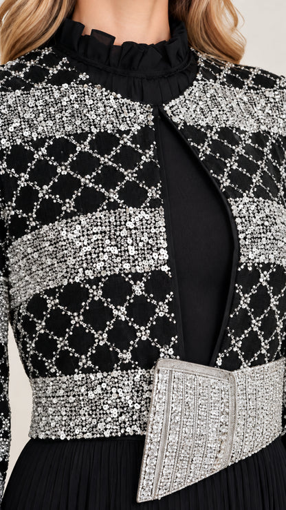 Close-up detail of geometric sequin jacket overlay and crystal waist belt