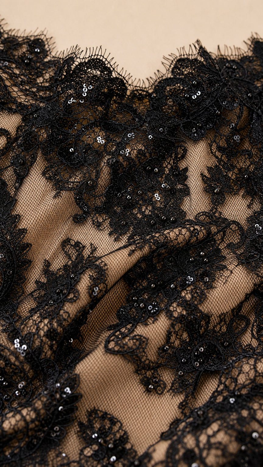 Close-up detail of floral eyelash lace and sequin embroidery