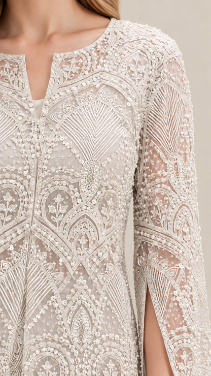 Close-up detail of intricate lace embroidery and notched neckline