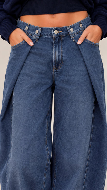 Close-up detail of waistband and denim styling with cropped knit hem