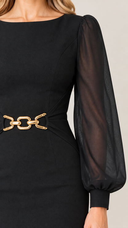 Close-up of gold chain waist accent and sheer cuff detail on black dress