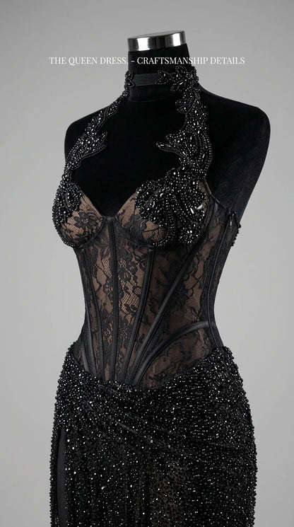 Mannequin close-up showing intricate beading, sheer lace, and boning on black corset gown