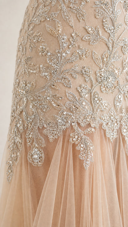 Close-up detail of intricate floral beadwork and sheer tulle hem