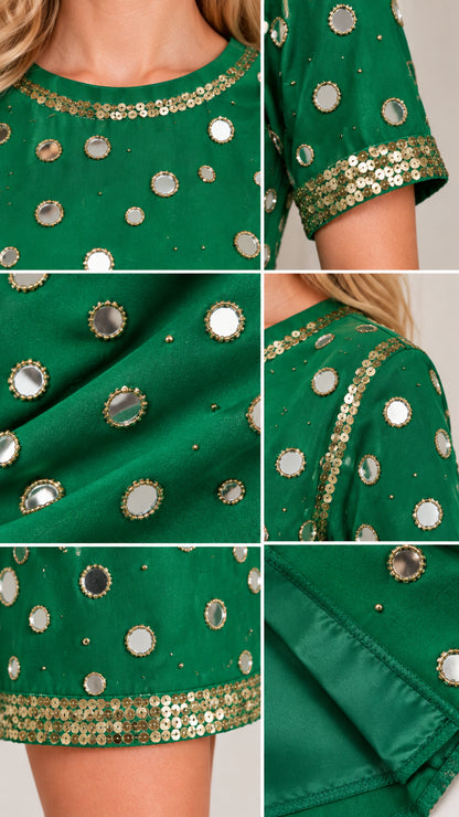 Close-up details of neckline, sleeve trim, and mirror embellishments