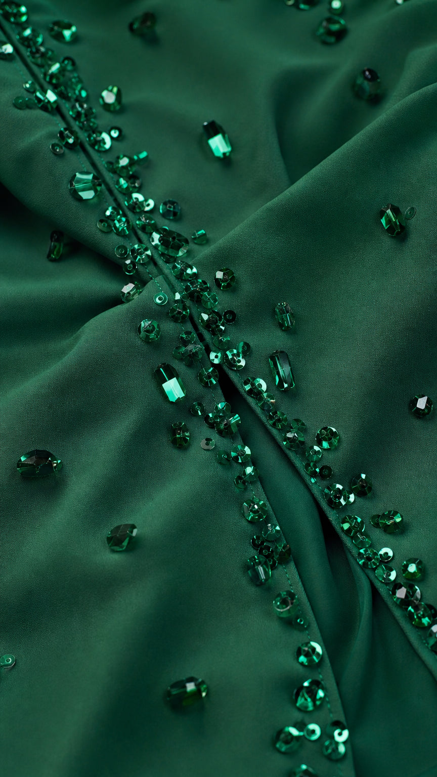 Close-up detail of Emerald Green fabric with hand-sewn crystal and bead trim