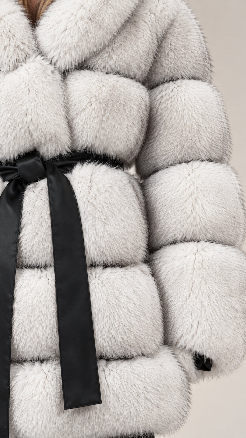 Close-up texture detail of soft plush faux fur material and contrast black belt