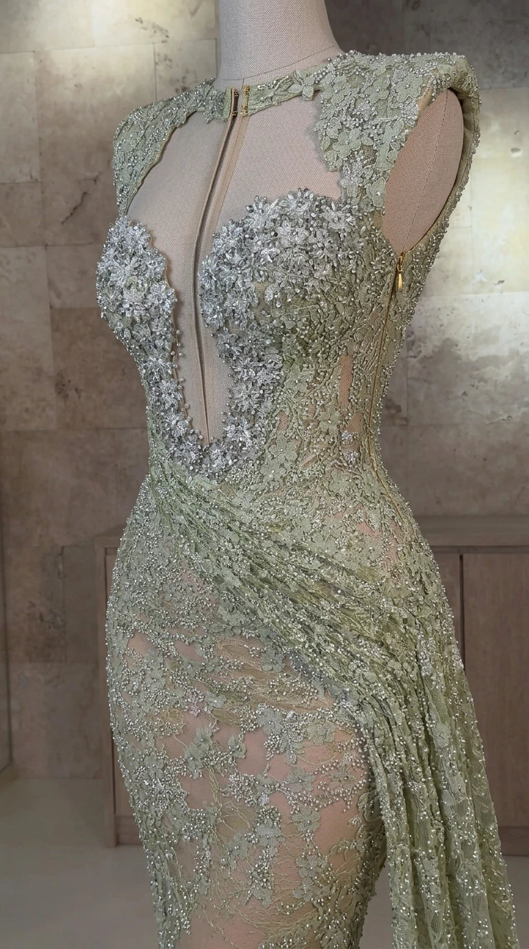 Close-up detail of sheer illusion plunge bodice and crystal beadwork on sage green gown