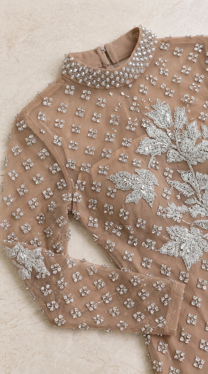 Close-up detail of high neckline, floral embroidery, and crystal beadwork