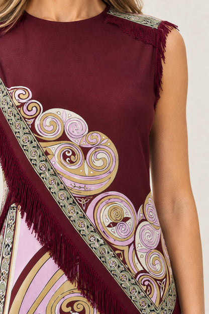 Close-up detail of baroque swirl pattern and fringe trim on Burgundy mini dress
