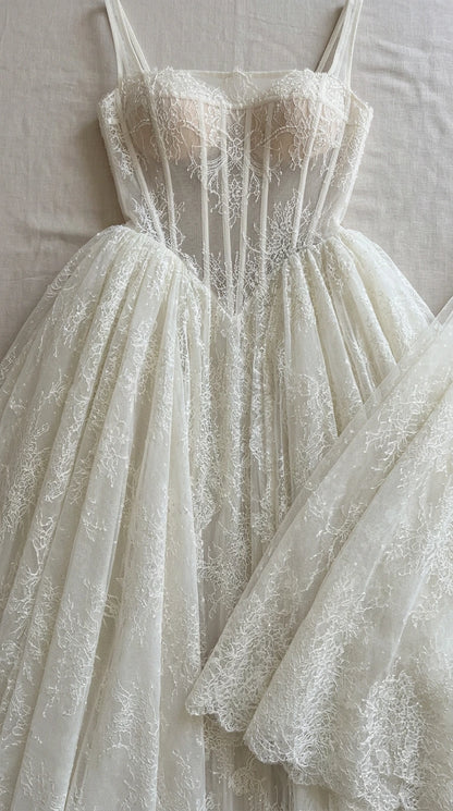 Flat lay close-up detail of Ivory corset bodice and lace fabric