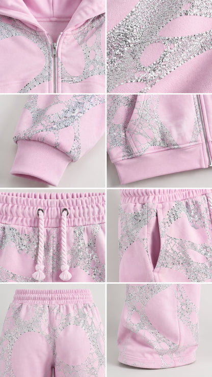 Close-up detail shots of pink tracksuit showing zipper, glitter graphic, drawstring, pockets, and ribbed cuffs