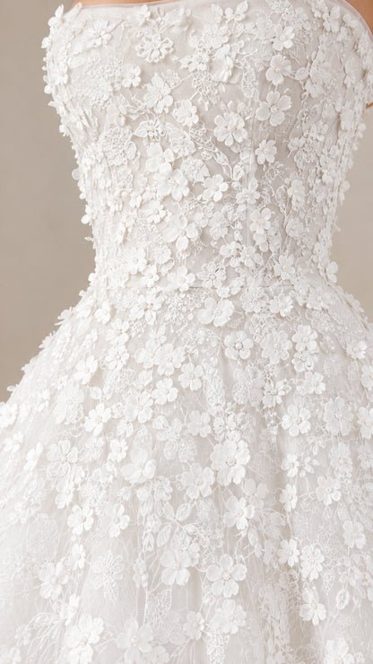 Close-up detail of 3D floral lace appliques on strapless bodice
