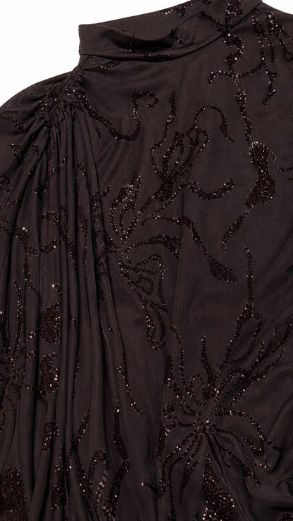 Close-up detail of shimmering floral beading on espresso fabric