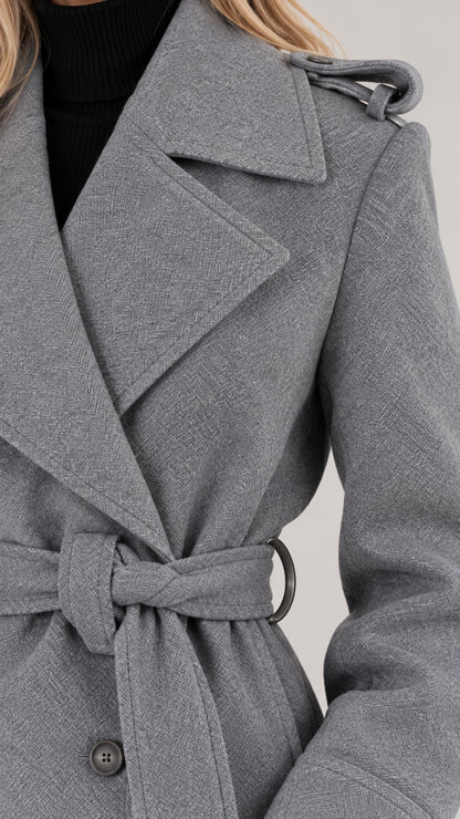 Close-up of grey textured fabric, lapel, and shoulder detail