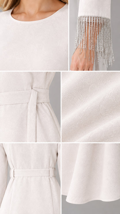 Close-up details of neckline, fabric texture, and shimmering fringe cuff
