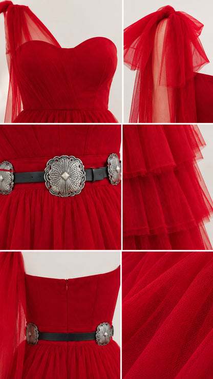 Close-up details of red sweetheart neckline, tulle shoulder bow, belt, and tiered ruffles
