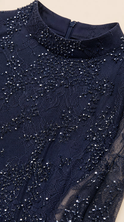Close-up detail of navy blue sequined lace fabric and mock neckline with zipper