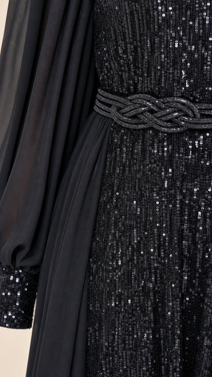 Close-up of black sequin texture, braided waistline detail, and sheer chiffon sleeve